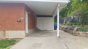 View of parking / parking lot with a carport