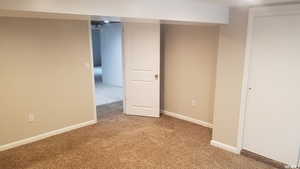 Unfurnished bedroom featuring light colored carpet