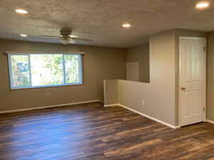 Empty room with recessed lighting, ceiling fan, and dark wood-type flooring