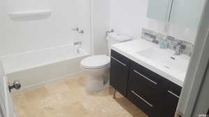 Full bath with vanity, shower / tub combination, and stone finish floors
