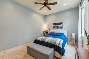 Carpeted bedroom featuring recessed lighting and a ceiling fan