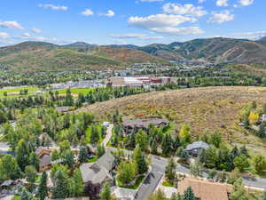 Aerial view of property and surrounding area with a mountain backdrop