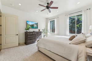 Bedroom featuring recessed lighting, light carpet, and ceiling fan