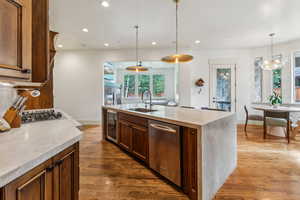 Kitchen featuring appliances with stainless steel finishes, wine cooler, dark wood-style flooring, recessed lighting, and light countertops