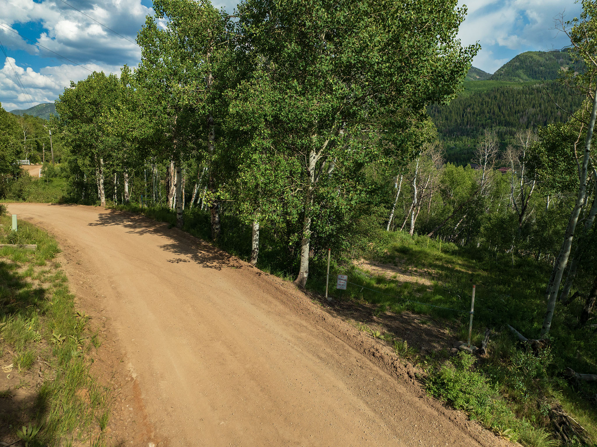 View of dirt / gravel road featuring a mountain view