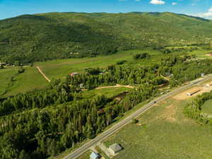 Aerial view of property and surrounding area with mountains