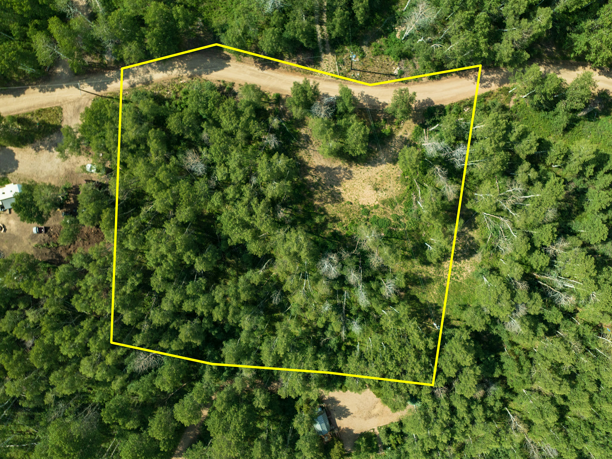Aerial view of property and surrounding area featuring property parcel outlined