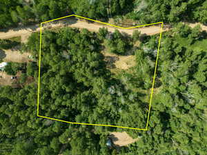 Aerial view of property and surrounding area featuring property parcel outlined