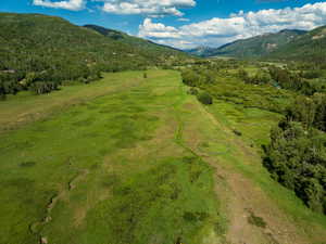 Aerial view of property's location featuring a mountainous background