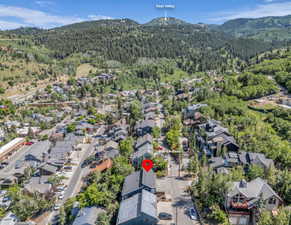 Aerial view of property and surrounding area featuring nearby suburban area