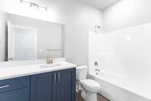 Bathroom with vanity, shower / washtub combination, and wood finished floors