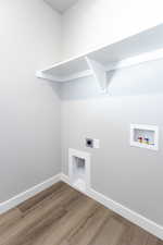 Laundry area featuring washer hookup, hookup for an electric dryer, and wood finished floors