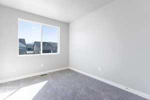 Unfurnished room with carpet and baseboards