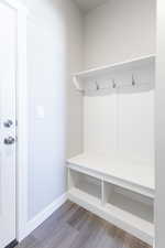 Mudroom featuring wood finished floors and baseboards