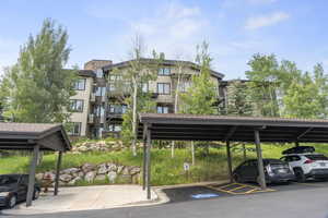 View of property featuring covered parking