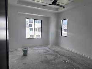 Unfurnished room with ceiling fan and baseboards