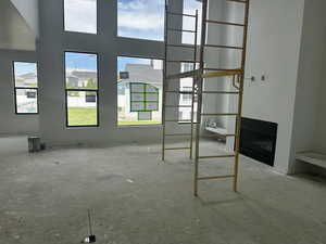 Unfurnished living room with healthy amount of natural light and a fireplace