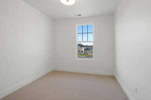 Spare room with light colored carpet