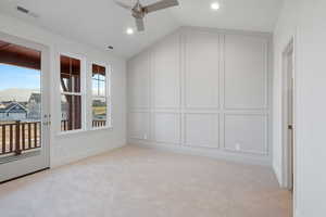 Unfurnished room with a decorative wall, a ceiling fan, vaulted ceiling, light carpet, and recessed lighting