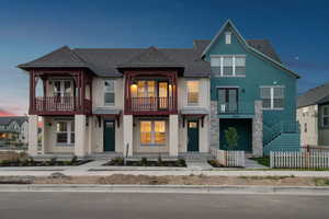 Multi unit property with a balcony, stucco siding, a shingled roof, and french doors