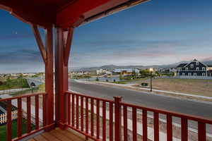 Wooden terrace featuring a water and mountain view