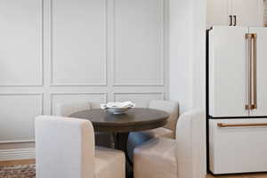 Dining room featuring wood finished floors and a decorative wall