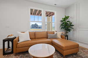 Living area with wood finished floors and baseboards
