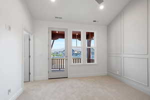 Carpeted spare room with a ceiling fan and recessed lighting