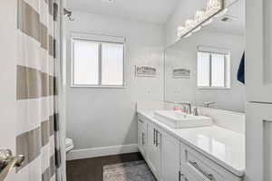 Bathroom featuring vanity and wood finished floors