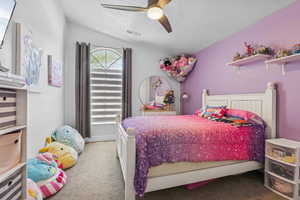 Bedroom featuring carpet floors, a textured ceiling, a ceiling fan, and vaulted ceiling