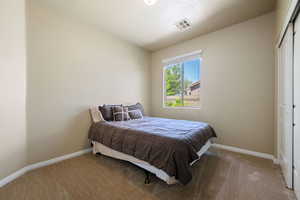 Bedroom with carpet flooring and a closet