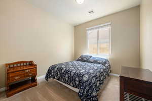 Bedroom featuring carpet flooring and baseboards