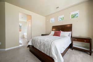 Bedroom with carpet flooring and ensuite bath