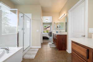 Ensuite bathroom with a stall shower, vanity, a bath, and tile patterned floors