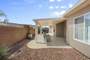 Fenced backyard with a patio