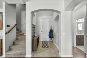 Entrance foyer featuring arched walkways and stairs