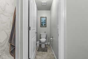 Bathroom featuring toilet and baseboards