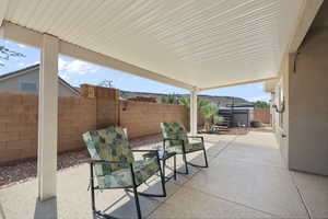 Fenced backyard with a patio and a jacuzzi