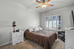 Bedroom with carpet and ceiling fan
