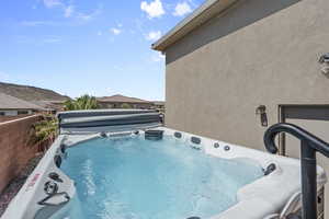 View of swimming pool featuring a hot tub
