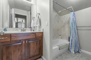 Bathroom with vanity and a textured ceiling