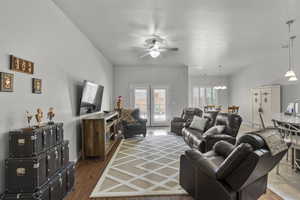 Living area with ceiling fan and a chandelier