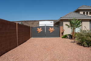 View of property exterior with a gate, stucco siding, and a tile roof