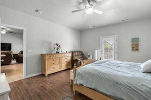 Bedroom with access to exterior, wood finished floors, and ceiling fan