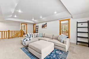 Living room with carpet flooring, recessed lighting, and vaulted ceiling