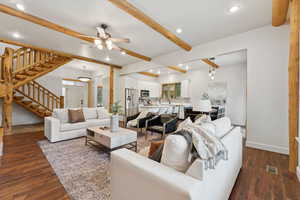 Living room featuring beam ceiling, recessed lighting, stairway, dark wood-style floors, and a ceiling fan