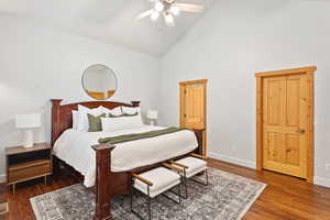 Bedroom with high vaulted ceiling, wood finished floors, and a ceiling fan