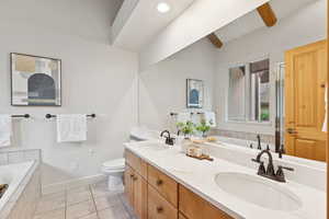 Full bathroom with double vanity, a bath, tile patterned flooring, and a stall shower
