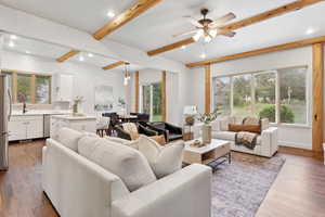 Living area with beamed ceiling, dark wood-style floors, a ceiling fan, and recessed lighting