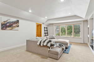 Living area featuring recessed lighting, light carpet, and vaulted ceiling